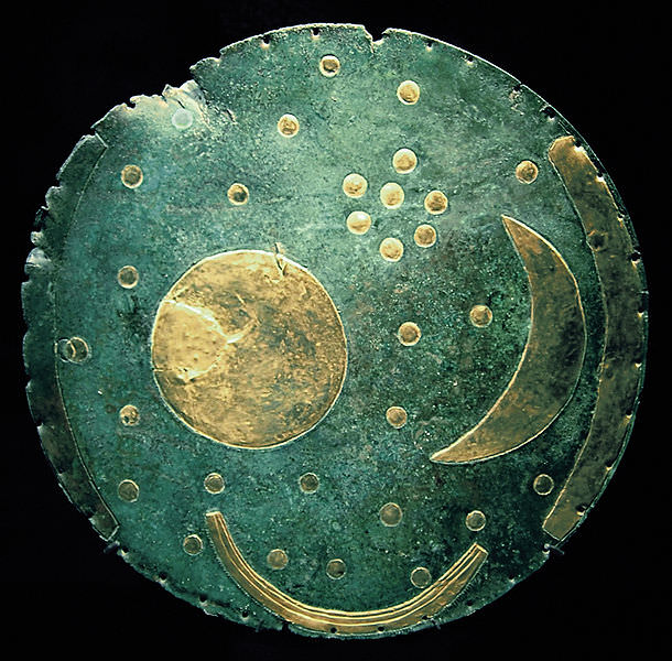 The Nebra Sky Disc from the bronze age, is blue with moons, stars and planets and phases of the moon